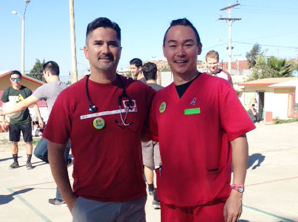 John Rodarte, MD, left, stands with second-year medical student Jeremiah Wang during the November volunteer trip to the Healing Hearts Across Borders clinic in Tijuana, Mexico.