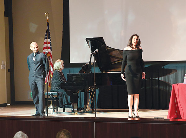 Award-winning bass-baritone Cedric Berry, left, looks at soprano Lisa Eden as she sings during a performance of La Ci Darem La Mano by Mozart, with piano accompaniment by Zora Mihailovich, at a Visions and Voices event titled, "Music and Medicine," held March 31 at Mayer Auditorium on the Health Sciences Campus.