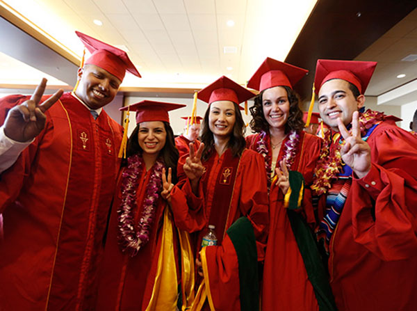 Graduates show their Victory signs before the Keck School of Medicine of USC MD/PhD and MD commencement ceremony May 14, 2016 at the Galen Center.