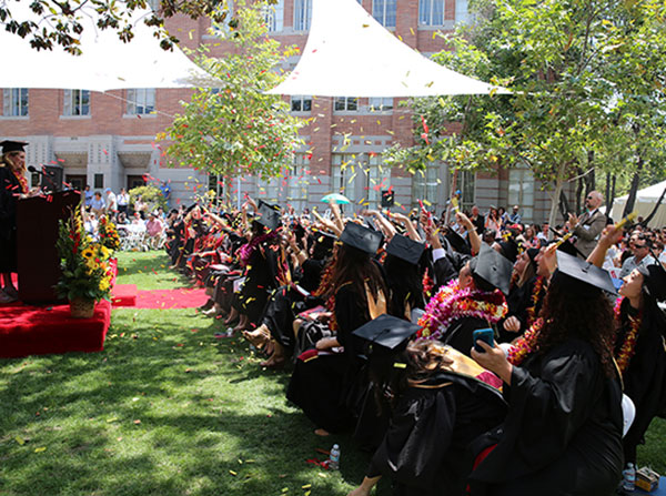 Students throw cardinal and gold confetti in celebration at the end of the Primary Care Physician Assistant satellite commencement ceremony on May 13, 2016 at the University Park Campus.