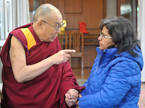 Soma Sahai-Srivastava, right, shakes hands with the Dalai Lama during a January visit to Dharamsala, India.