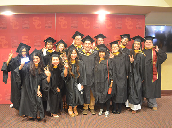 Members of the inaugural Master of Neuroimaging and Informatics class show their Victory signs before the PhD, MPH and Master's degree satellite commencement ceremony for the Keck School of Medicine of USC, held May 14 at the Galen Center.