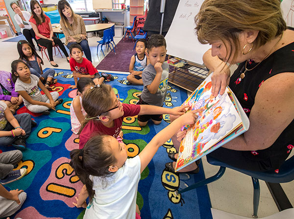 Three-week summer program of community outreach improves reading and writing skills with interventions for students, parents and teachers