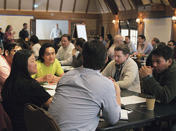 From left, Katherine Kim of University of California, Davis; Yi Wang of Indiana University; Lucas Mentch of University of Pittsburgh; and Roummel Marcia of University of California, Merced, exchange ideas for new wearable or ambient mobile sensors at the Data Science Innovation Lab held June 15-19 in Lake Arrowhead. 