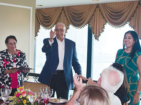 Jorge Motta, center, former director of the Gorgas Memorial Institute in Panama and National Secretary of Science, Technology and Innovation of Panama, receives the inaugural Health Equity Hero Award while Lourdes Baezconde-Garbanati, left, looks on. The award was given as part of a summit organized by the Keck School of Medicine of USC.