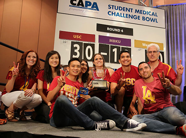 From left, Jennifer Ramos, Jie Zhuang, Matthew Tan, Sarah Nargiso, Nicole Galle, Andrew Luna, Dane Arispe and Christopher P. Forest pose with the California Academy of Physician Assistant Challenge Bowl trophy.