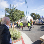 Dr. Arthur W. Toga watching as construction workers load the 7T MRI
