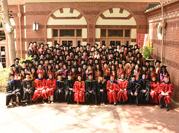 Graduates from the Keck School of Medicine of USC’s Health Promotion and Global Health programs take a class photo after commencement. (Photo/Grad Images)