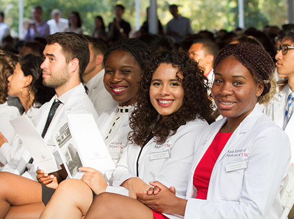 Incoming medical students don white coats for the first time