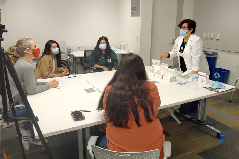 Nurse navigator Daphne Bautista demonstrates tracheostomy equipment during a training session. (Photo/Tamara Tervinskaya)