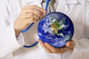 Photo of Globe with a doctor placing stethoscope on it