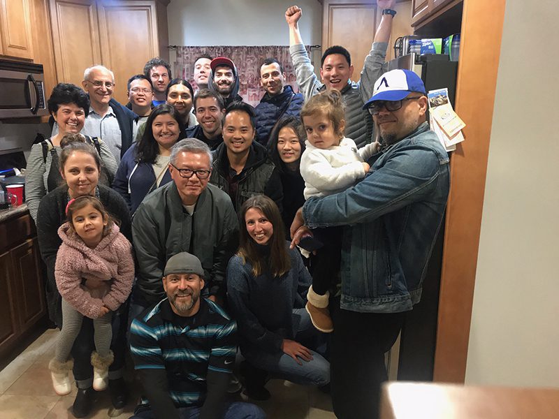 At this 2019 Segil Lab gathering, Neil Segil and Litao Tao are smiling on the far left side of the back row, and Haoze (Vincent) Yu is joyfully raising his arms in the air.