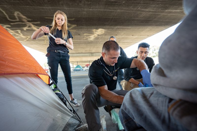 Brett Feldman, Eddie Menacho and Gabrielle Johnson work as part of the Street Medicine team at USC, which provides medical care to people who are living on the streets. (Photo/Chris Shinn)